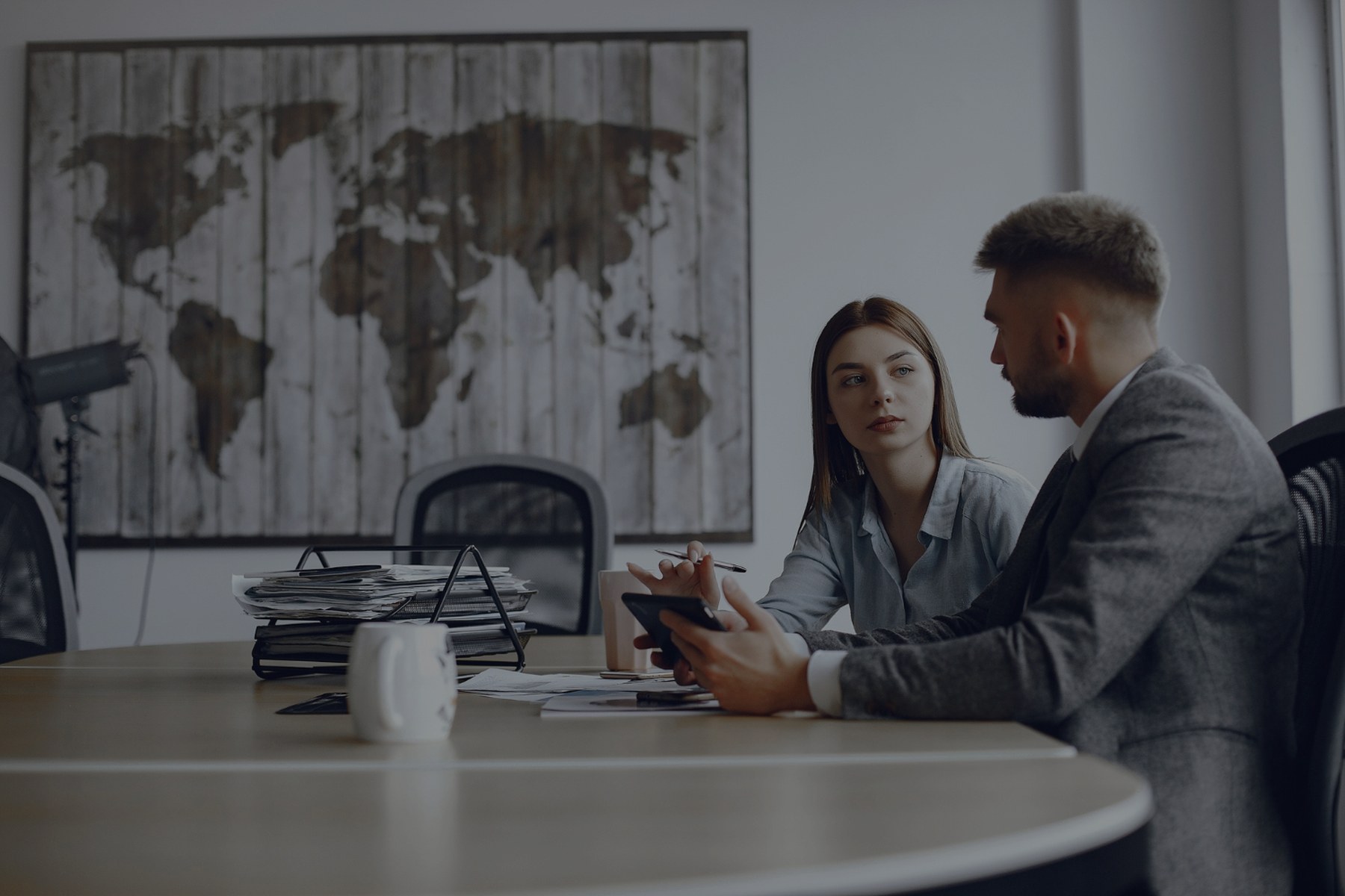 Senior consulting team reviewing a program roadmap in a boardroom